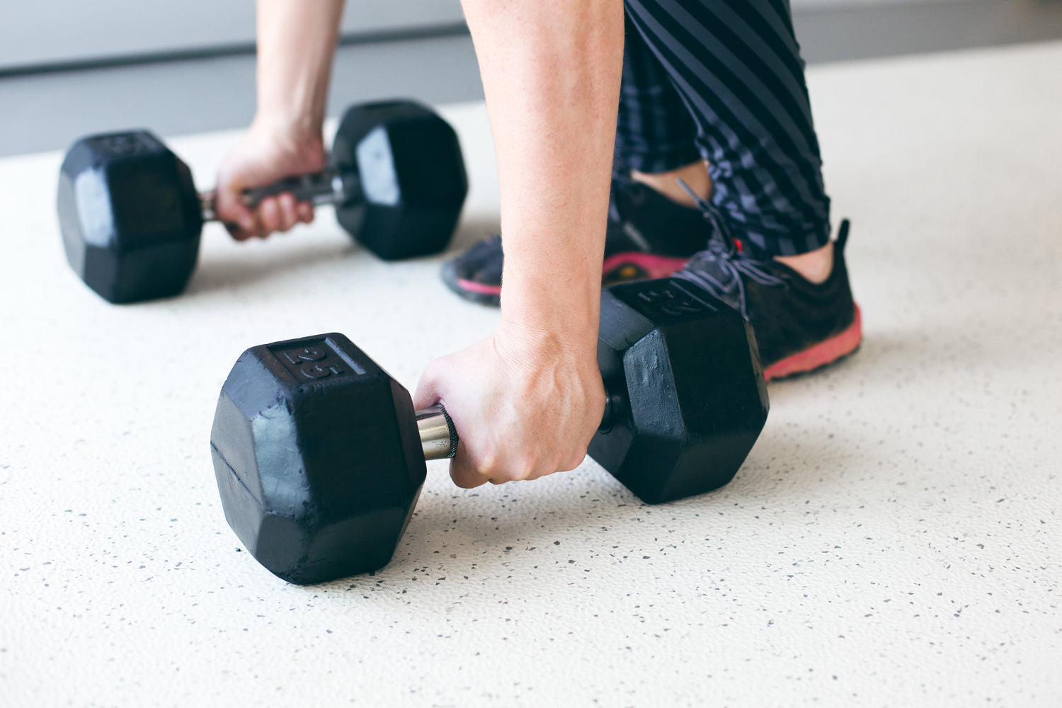 hands lifting dumbbells